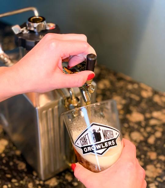 Pouring a pint of beer from our 128 oz stainless steel pressurized growler.