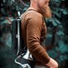 man carrying pressurized growler with growler caddy on a hike.