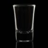 1oz shooter shot glass on a black backgound and backlit.