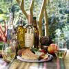 20oz stemless wine glasses set with a wine and cheese platter on a wooden table.