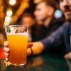 gentleman holding pint of beer in a 19oz imperial nonic style pint glass