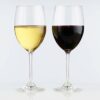 two 19oz stemmed wine glasses, one full of red and the other full of white wine.