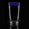 handblown glass 3.75 shooter shot glass on a black background with a cobalt blue rim.