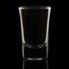 flared 1.75oz shot glass backlit on a black background.