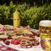 19oz dimpled beer mug on a table with burgers, hotdogs and fries.