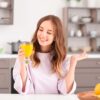 young woman enjoying a glass of orange juice in a 10oz glass goblet.